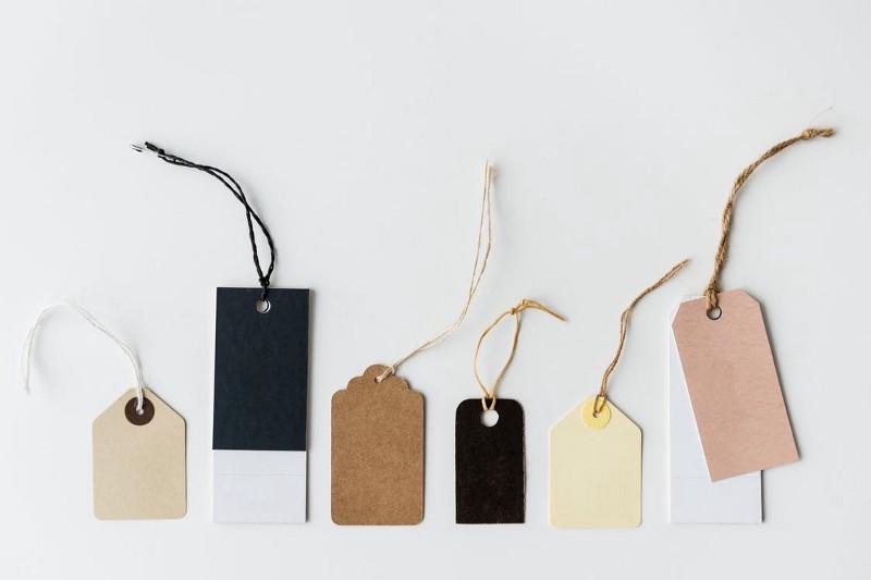 Six handmade package tags of various sizes and colors.