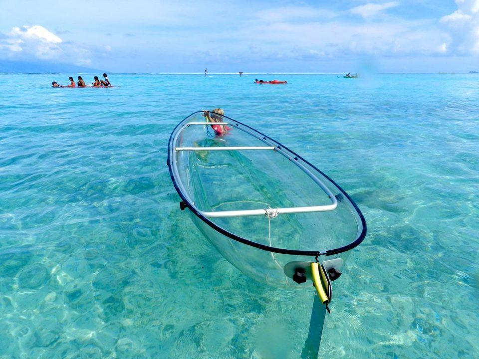 Clear boat on a crystal clear body of water.
