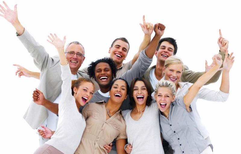 Group of people looking excited and all dressed in muted colors with a white background.